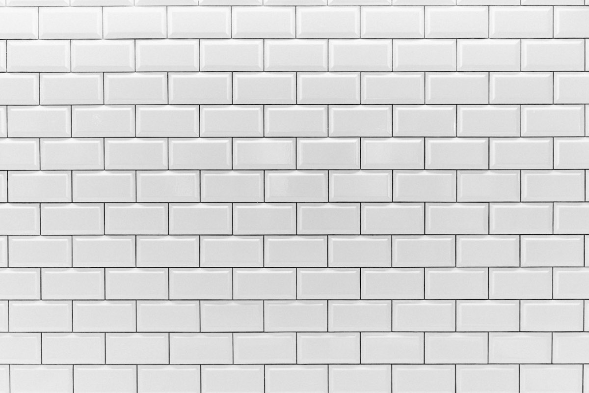Close-up of white bevelled gloss metro wall tiles